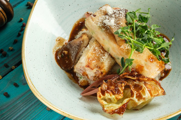 cheese strudel with mushrooms and herbs sprinkled with grated Parmesan and green peas