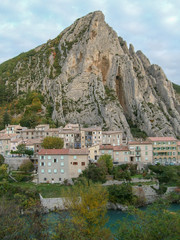 Small town at the foot of rocky mountain next to the turquoise river.  Provence-Alpes-Côte d'Azur. French riviera, France
