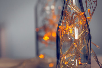 Lights garland in a glass bottle on a dark background