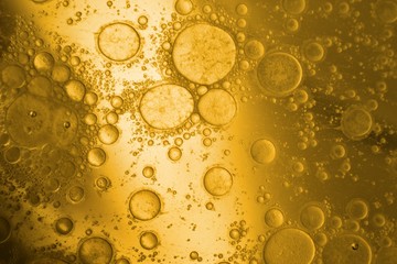 Yellow cooking oil bubble on water