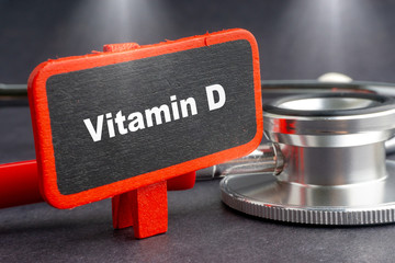 VITAMIN D. Medicine concept. Blackboard with word VITAMIN D and stethoscope