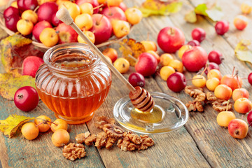 Red and yellow crab apples with honey and walnuts, healthy organic food.