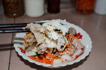 Khmer-Vietnamese noodles fusion food in Toul Tom Pong market( Russian market) in phnom Penh, Cambodia, Ingredients is rice noodle, spring-rolls, pork, carrots and top with ground nuts