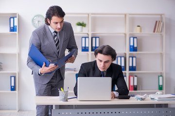 Fototapeta premium Two young employees working in the office