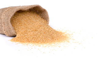 Closeup brown sugar in sack isolated on white background.