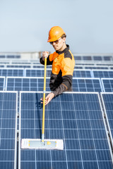 Workman cleaning solar panels