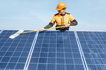 Workman cleaning solar panels