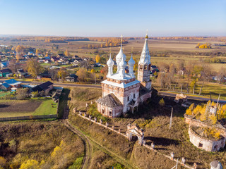 Fototapeta na wymiar Church of the Holy Virgin in the village of Dunilovo on a sunny autumn day, Ivanovo region, Russia. Shooting from the drone