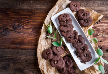 Homemade biscuits made from coffee, cocoa and chocolate served on a wooden board as a pastry for Christmas or other holidays