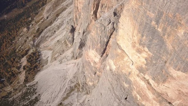 Drone aerial video in the morning light  to the great Tofana of Rozes south East wall, special and famous dolomite rocks , near Cortina D'Ampezzo.