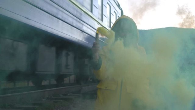 Protest demonstration blockade blocking protests rebellion politician political repressions Woman with color green smoke bomb staying near man transport artery highway railway and waving colored smoke