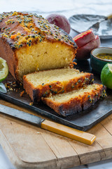 Lime and passion fruit drizzle cake on wooden board