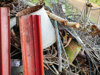 Mountain of garbage close-up. Big Mountain With Nobody Care Of Nature, Modern Environment Trash. Foreground sharp, background blurred. Background of rusty scrap metal.