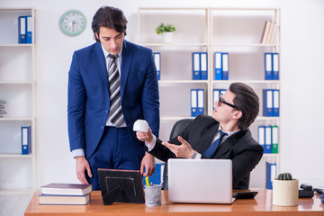 Boss and his male assistant working in the office