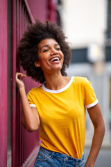 beautiful african american woman laughing outside in city