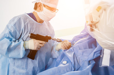 Arthroscope surgery. Orthopedic surgeons in teamwork in the operating room with modern arthroscopic...