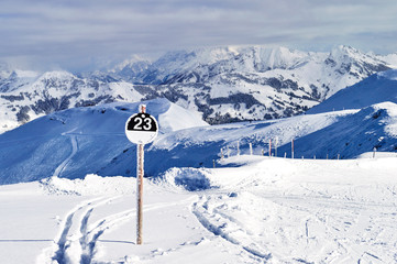 a round black sign indicating a very difficult ski track for experts, located in the Austrian Alps...