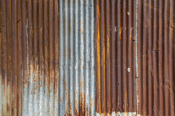 Rusted galvanized iron plate, red stain on old metal sheet wall texture.