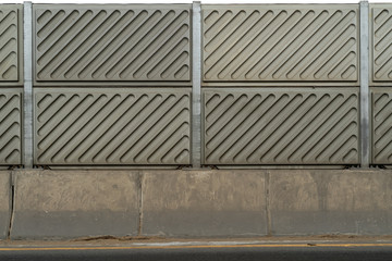 Fiber Noise barrier near road side. Noise barrier wall on a highway near railway station.