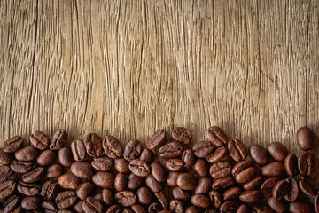 Coffee beans on old wood background 