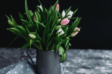  Pink and white tulips in a vase on the table