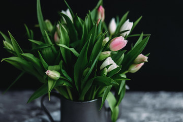  Pink and white tulips in a vase on the table