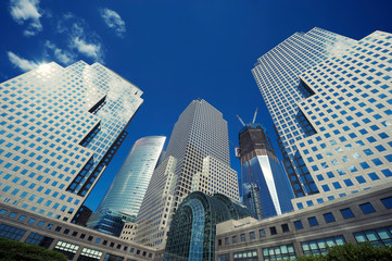 Classic city skyline of shiny glass office tower skyscrapers with blue sky