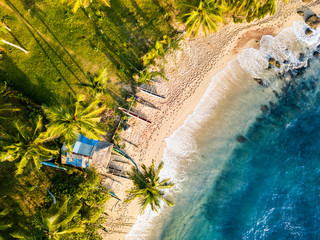 Romantic sunset on a tropical beach with palm trees