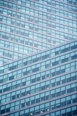 Fototapeta na wymiar Abstract geometric background of a modern glass office tower skyscraper 
