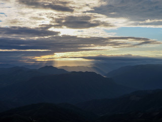 Photo from the highest peak of Pui Ko mountain, Mae Hong Son, Thailand. The sun shines down over the complex mountains in the early morning.