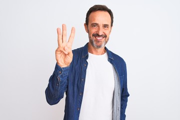 Middle age handsome man wearing blue denim shirt standing over isolated white background showing...