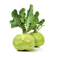 green kohlrabi with gracefully furled leaves on an isolated white background.