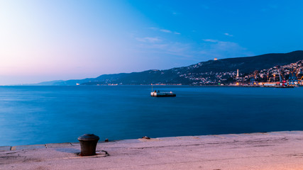 Colorful sunset in front of the city of Trieste