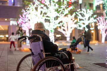 Elderly woman in wheelchair watching illumination  車椅子に乗ってイルミネーションを見ているシニア女性