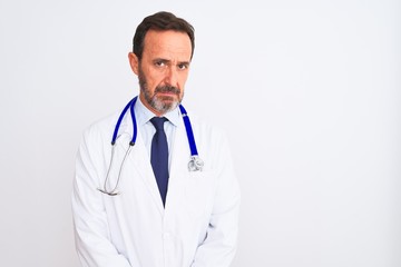 Fototapeta premium Middle age doctor man wearing coat and stethoscope standing over isolated white background skeptic and nervous, frowning upset because of problem. Negative person.