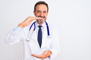 Middle age doctor man wearing coat and stethoscope standing over isolated white background...