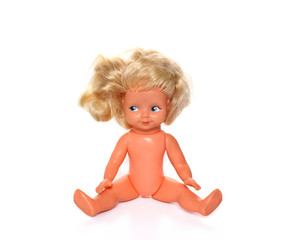 Old baby doll with uncombed hair, toy isolated on a white background.