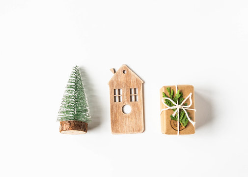 Flat lay Christmas concept composition - Christmas tree, wood home and gift on white background. top view, copy space