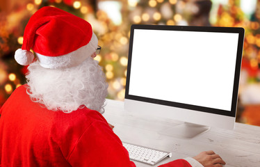 Santa Claus work on computer. Isolated, blank screen for mockup, app or web site presentation....