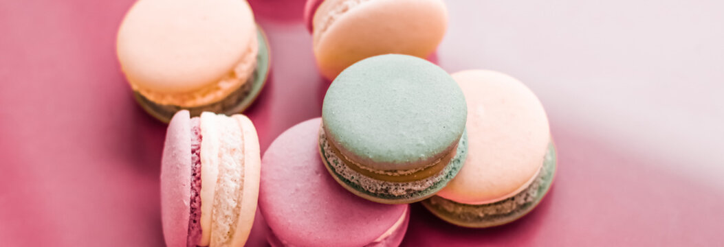 French macaroons on pastel pink background, parisian chic cafe dessert, sweet food and cake macaron for luxury confectionery brand, holiday backdrop design