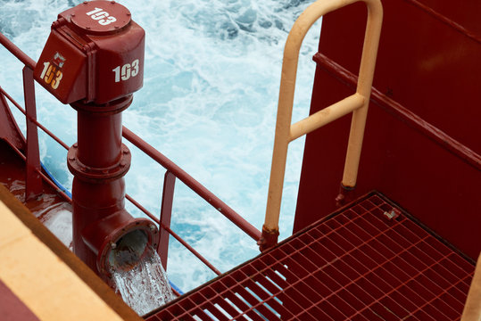 View of Ballast Water exchange process onboard of a ship using flow-through method underway in open ocean. Overflow method through ballast tank air head.