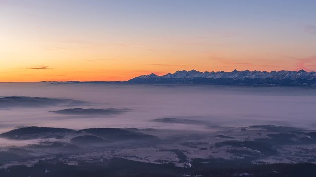 Sunrise over Tatra mountains seen from Babia mountain with cloud inversion.