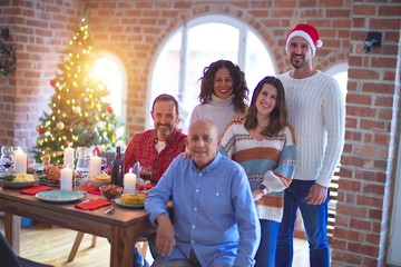 Beautiful family smiling happy and confident. Posing with tree celebrating Christmas at home