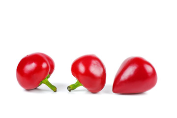 Three red sweet peppers