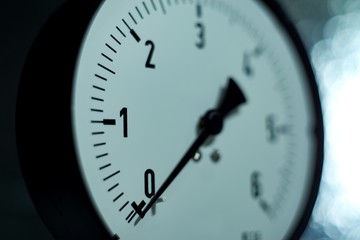 Gas pressure gauge on technical and machine background.