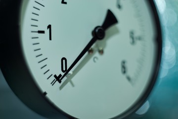 Gas pressure gauge on technical and machine background.