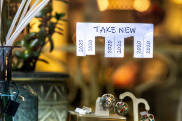 Christmas shop window with paper with the phrase: Take New and with a 2020 sign ready to be tore off