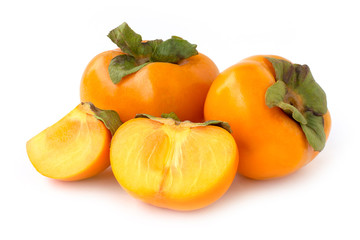 Closeup fresh orange organic ripe Fuyu Persimmons or Persimon fruits with sliced isolated on white...