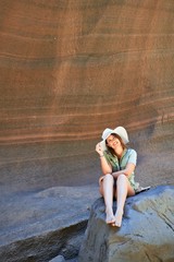 Young beauitufl hiker woman trekking natural orange mountain on summer holidays