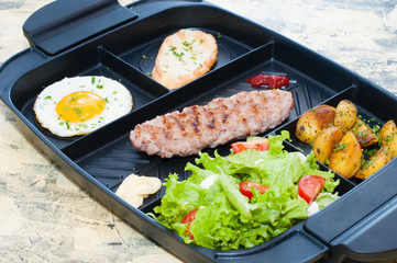 Breakfast, fried steak or cutlet, salad with tomato and green vegetables, toast, potato, egg closeup, light background. Concept healthy eating, diet, menu, nutritious food.